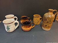 Front view of all six pieces showing designs and glazing