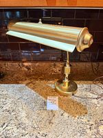 Full view of brass desk lamp on counter