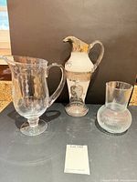 Front view showing Waterford glass jug, hand-painted jug and textured vase