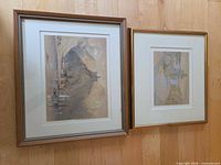 Both framed paintings side by side