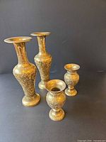 Four etched brass floral vases, group view