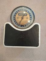 Front view of cast iron scale showing platform and dial