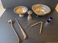 Lot overview showing both bowls, pepper mill, snuffer, letter opener, picks, nutcracker, salt cellars