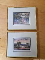 Both framed prints, one above the other