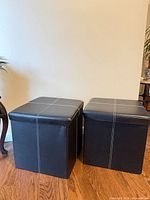 Two brown faux leather cube ottomans side by side showing exterior surfaces