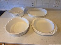 All four CorningWare dishes on countertop