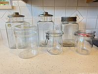 Group shot of all six clear glass canisters