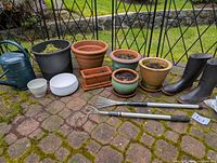 Group shot of all planters, watering can, boots and tools
