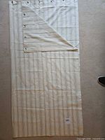 Full view of striped cotton shower curtain laid flat, showing overall pattern and size