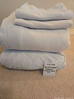 Stacked light blue flannel sheets and pillowcases