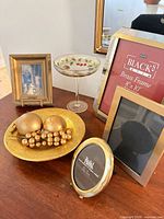 Group view showing frames, compote, bowl, candles