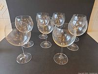 Group shot showing all eight matching red wine glasses