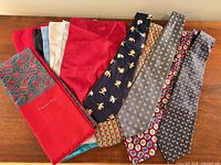 Full lot view: Christian Dior scarf, stacked pocket squares, five patterned neckties