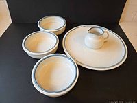 Entire five-piece Mikasa stoneware set displayed