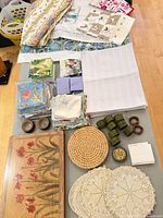 Overall lot view showing tablecloth, napkins, placemats, trivets, napkin rings and tea towels