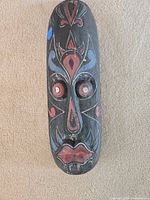 Front view of carved painted mask
