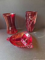 Group view: two ruby red glass vases and divided dish