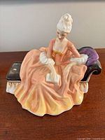 Front view of Royal Doulton Reverie HN2306 figurine on chaise lounge