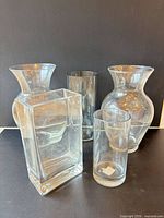 five clear glass vases arranged together