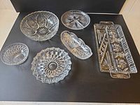 All six clear cut glass pieces arranged on surface
