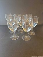 All eight clear stemmed wine glasses front view