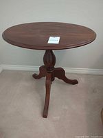 Full view of assembled table showing top, pedestal and legs