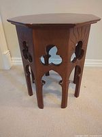 Full view of solid wood octagonal side table showing overall form and Gothic cut-outs