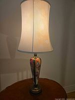 Full view of lit table lamp on table