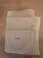 Folded white cotton/poly sheet set with lot sticker