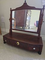 front view showing mirror, base and drawers