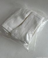 sealed bag with white ribbed socks visible