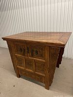 Front and side view of carved hardwood cabinet