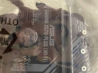 Motherboard label showing ASUS TUF Gaming X570-Plus (Wi-Fi) text through antistatic bag