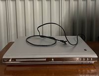 Front view of VisionQuest VQM6881 DVD player with power cord on top