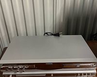 Front angled view of Malata MDYD-6828 player showing controls and disc tray