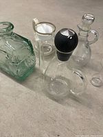 Four glass and porcelain items grouped on floor
