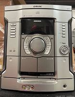 Front view showing controls, CD changer door, cassette deck