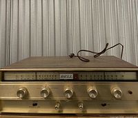 Front view showing faceplate, controls and dial