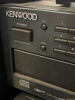 Kenwood logo, power switch, standby indicator, part of disc tray