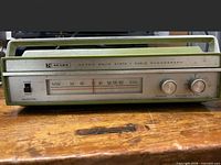 Front view showing dial, tuning and volume knobs, selector switch