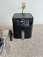 Front view of Cosori air fryer with utensils