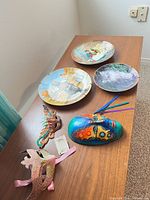 Overview of four plates and three masks on table