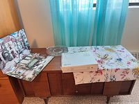 Serving stand box, etched platter, placemats, table runner displayed on console