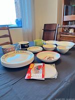 Entire mixed dinnerware set and jar opener pads on table