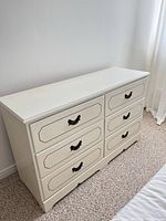 Front view showing six drawers and handles