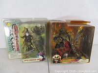 Both action figures in sealed packaging side by side