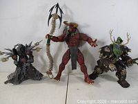 Front view of all three figures standing side by side