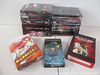 Group shot showing stacked anime DVD cases and three box sets