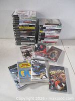 Front view showing stacked PSP game cases and several loose cases laid out