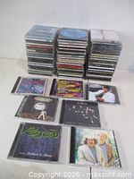 Front view two tall stacks of CDs with eight highlighted titles